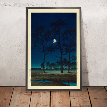 A framed image of Winter Moon over Toyama Plain by Hasui Kawase, 1931