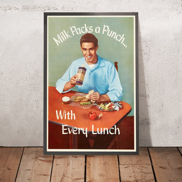 A framed image of Milk Packs a Punch Vintage Milk Poster, 1952