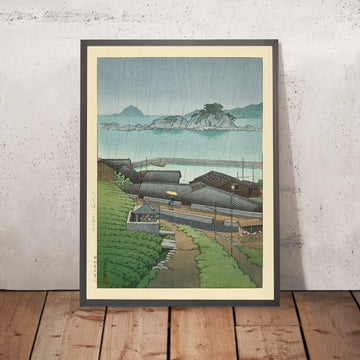 A framed image of Rainy Coastal Japanese Village by Hasui Kawase 1935