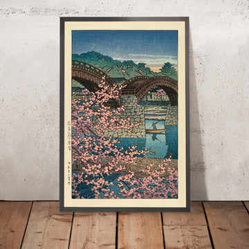 A framed image of Spring Evening Cherry Blossoms at Kintai Bridge by Hasui Kawase 1935